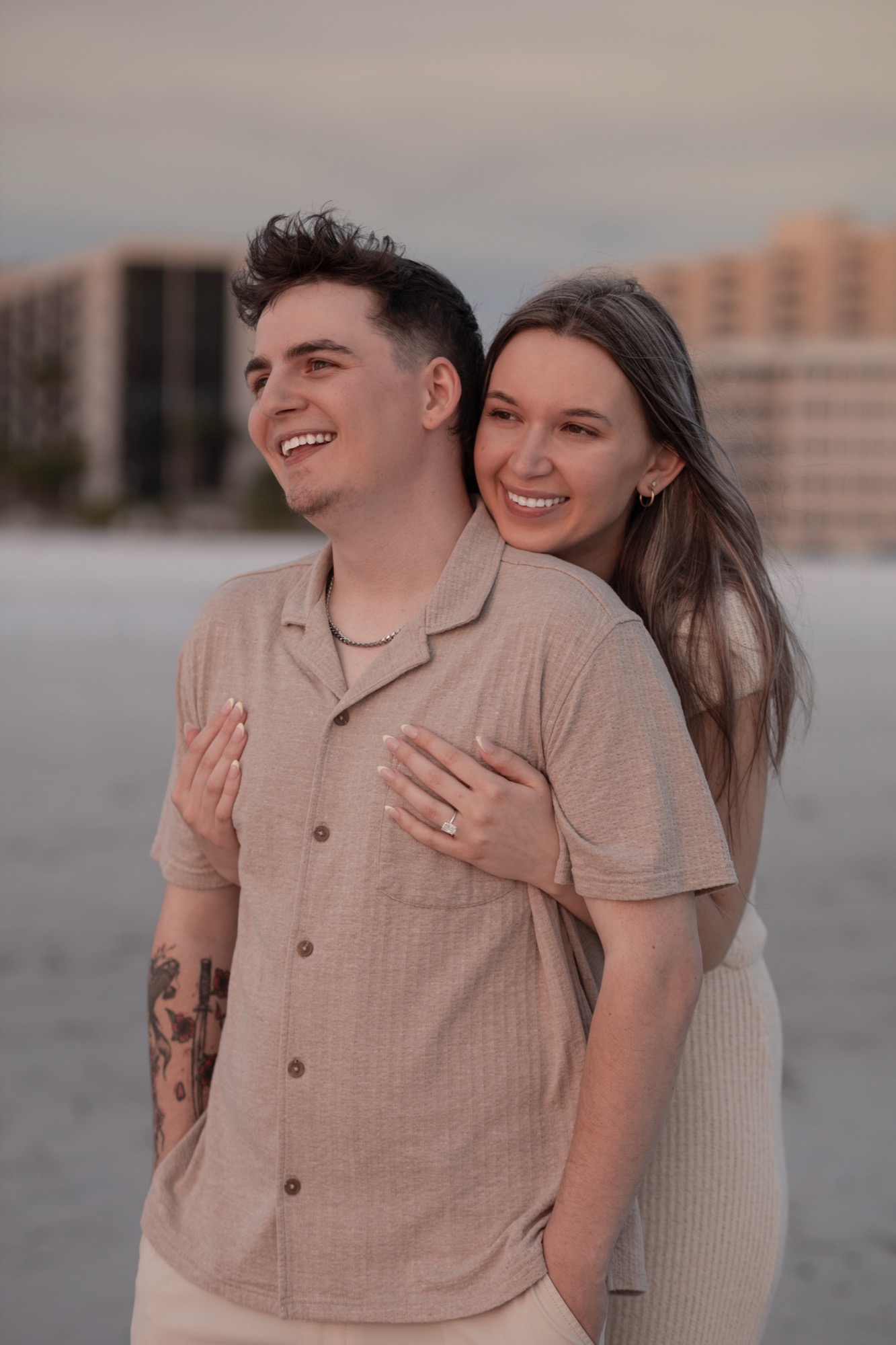 Engaged couple embracing on Anna Maria Island